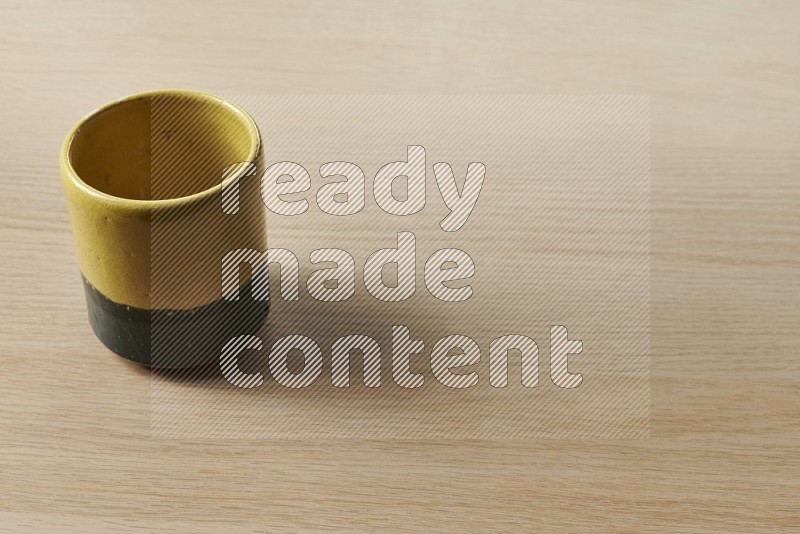 Multicolored Pottery Cup on Oak Wooden Flooring, 45 degrees