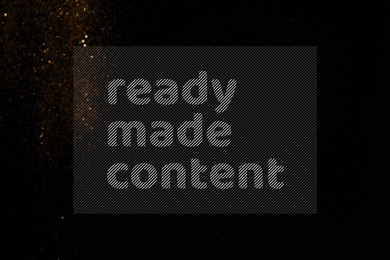 Gold glitter powder isolated on black background