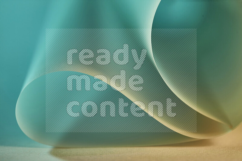 An abstract art piece displaying smooth curves in green and yellow gradients created by colored light