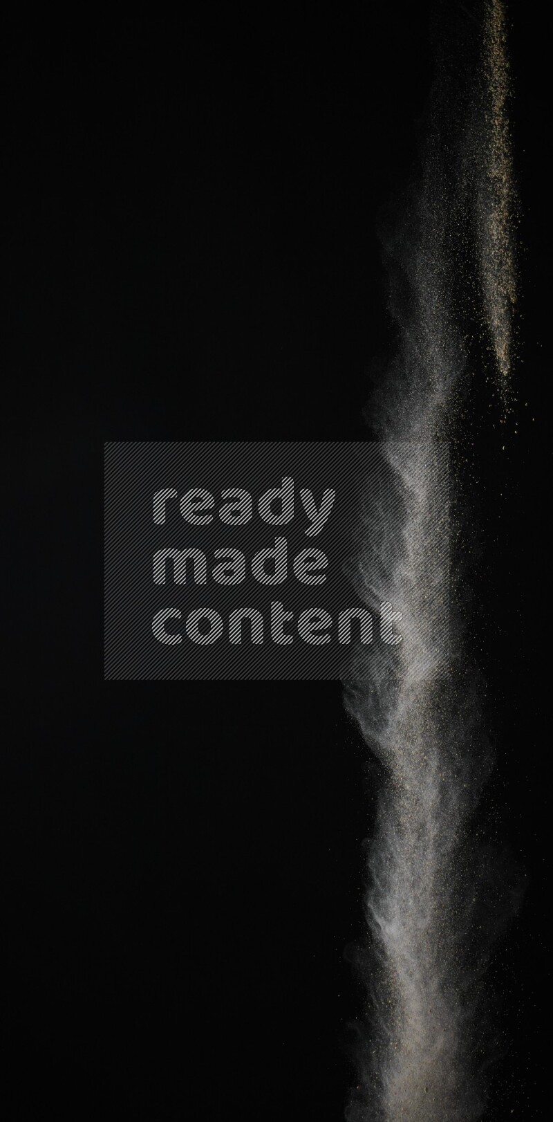 A side view of brown powder explosion on black background