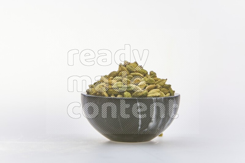 Cardamon in a container on white background