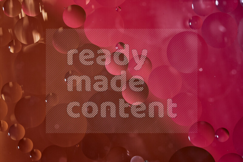 Close-ups of abstract oil bubbles on water surface in shades of red and orange