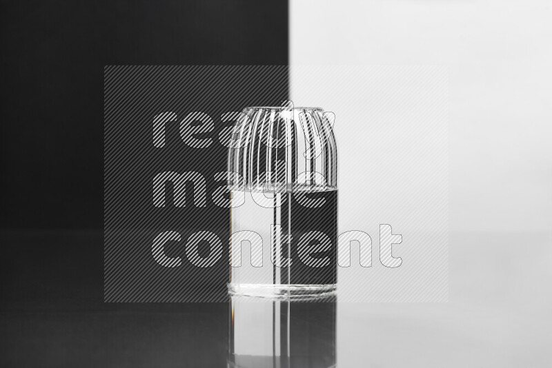 The image features a clear glassware filled with water, set against white and black background