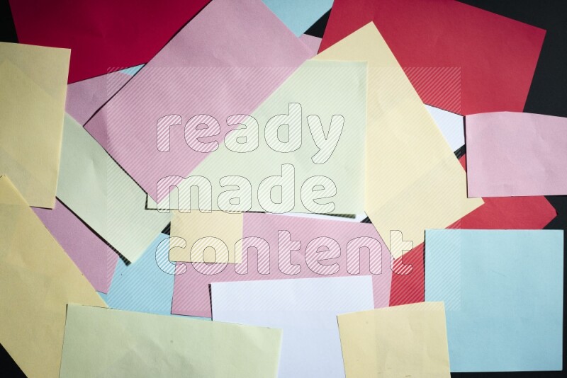 Multicolored paper sheet on black background