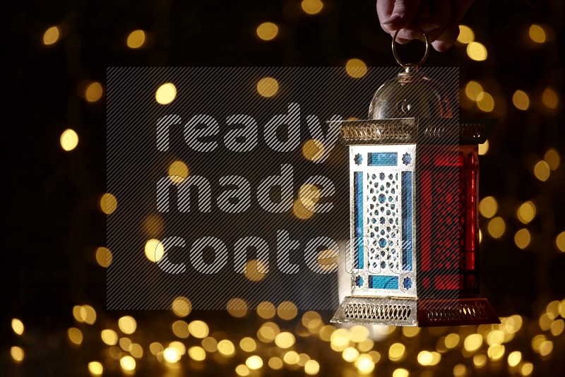 A traditional ramadan lantern surrounded by glowing fairy lights in a dark setup