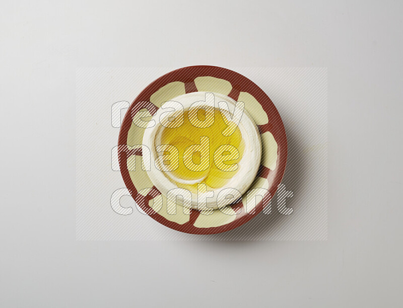 Lebnah garnished with olive oil in a traditional plate on a white background