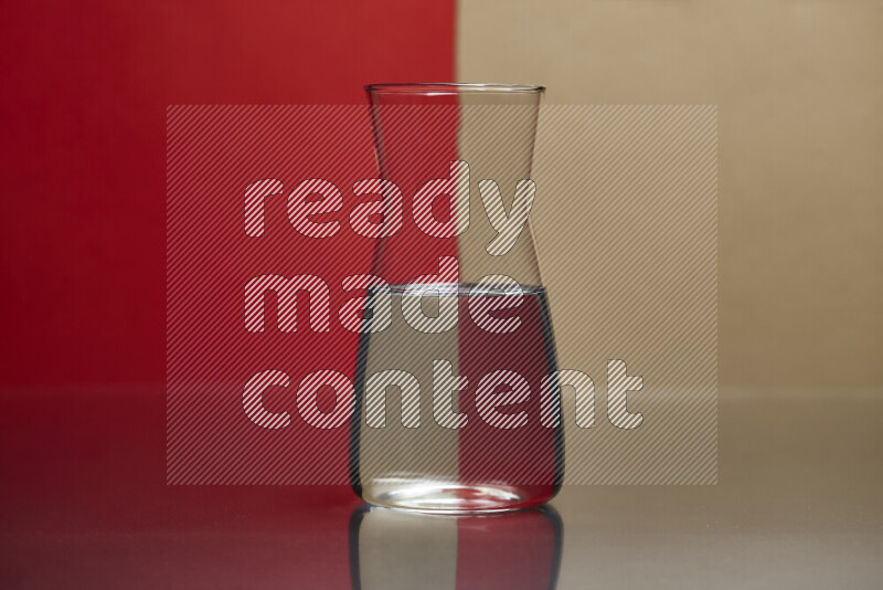 The image features a clear glassware filled with water, set against red and beige background