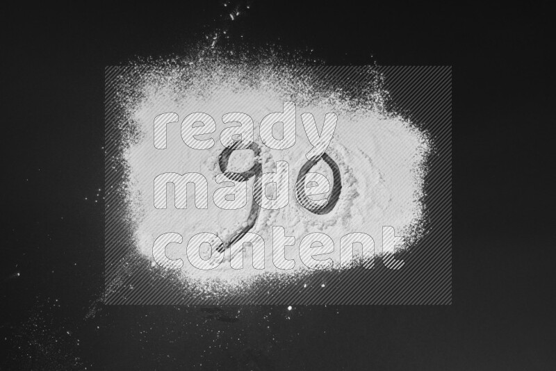 Numbers written with powder on black background