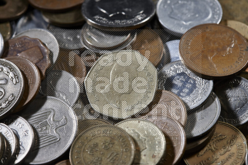 A close-ups of random old coins on black background