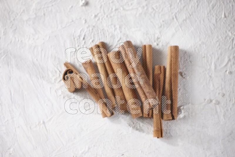 Cinnamon sticks on a textured white background