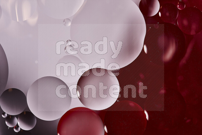 Close-ups of abstract oil bubbles on water surface in shades of white and red