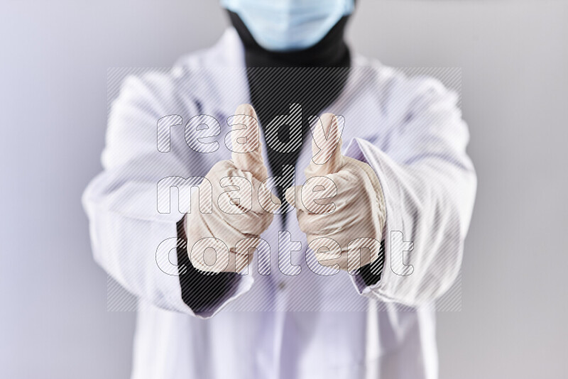 Female doctor wearing an abaya and medical attire in different positions