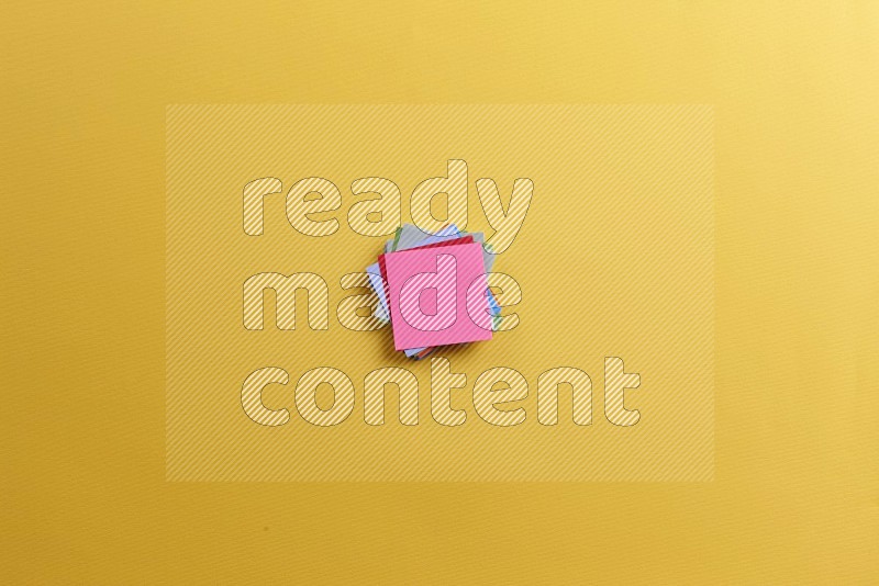 Multicolored sticky notes on yellow background (Back to school)