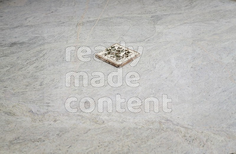 Top view shot of a pottery coaster\ tile on beige marble flooring