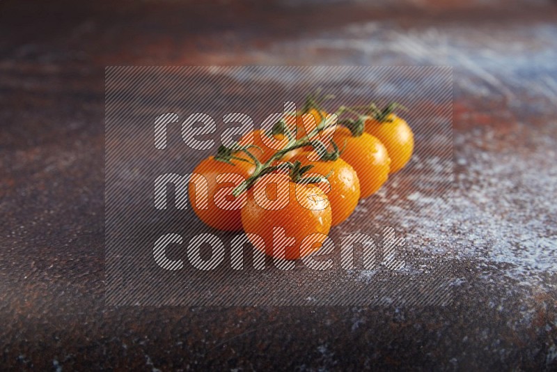 Orange cherry tomato vein on reddish rustic metal background 45 degree