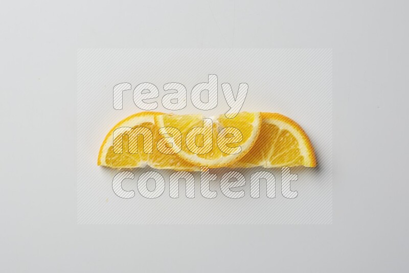 Three halves of an orange slices on white background