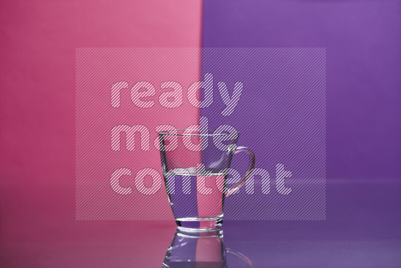 The image features a clear glassware filled with water set against pink and purple background