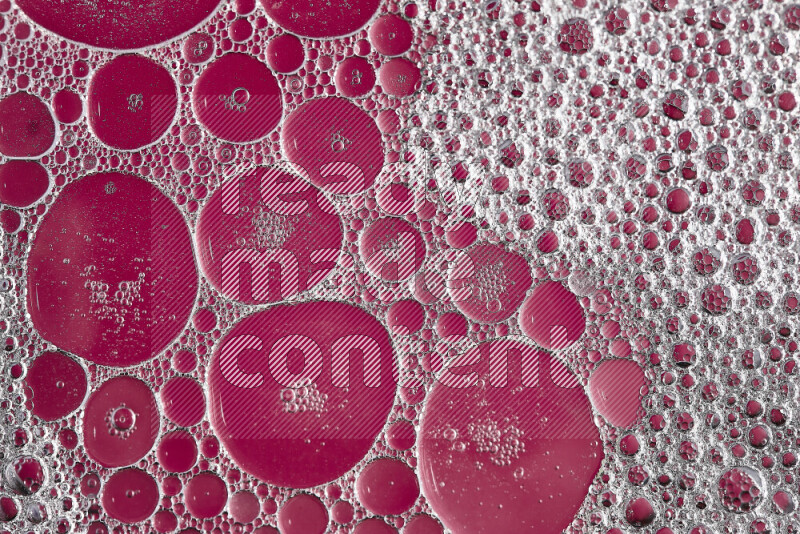 Close-ups of abstract soap bubbles and water droplets on pink background