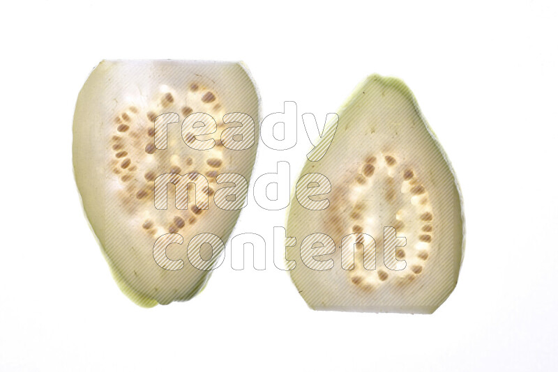 Guava slices on illuminated white background