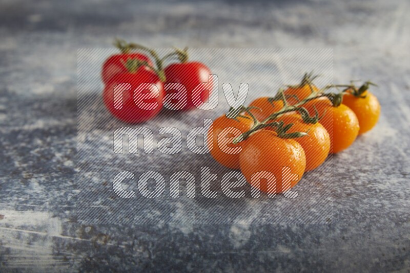 Mixed cherry tomato veins on a textured rustic blue background 45 degree