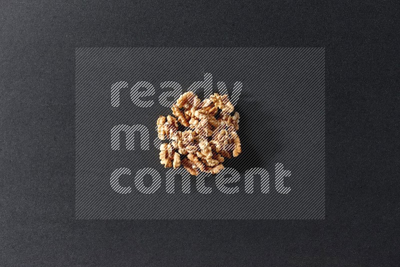 A bunch of walnuts on a black background in different angles