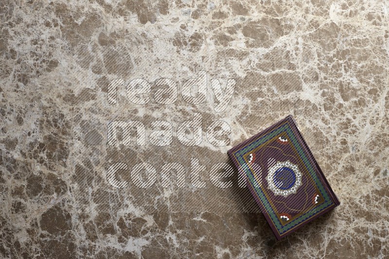 Quran on beige marble background