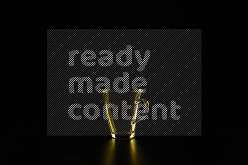 Glassware with rim light in yellow against black background