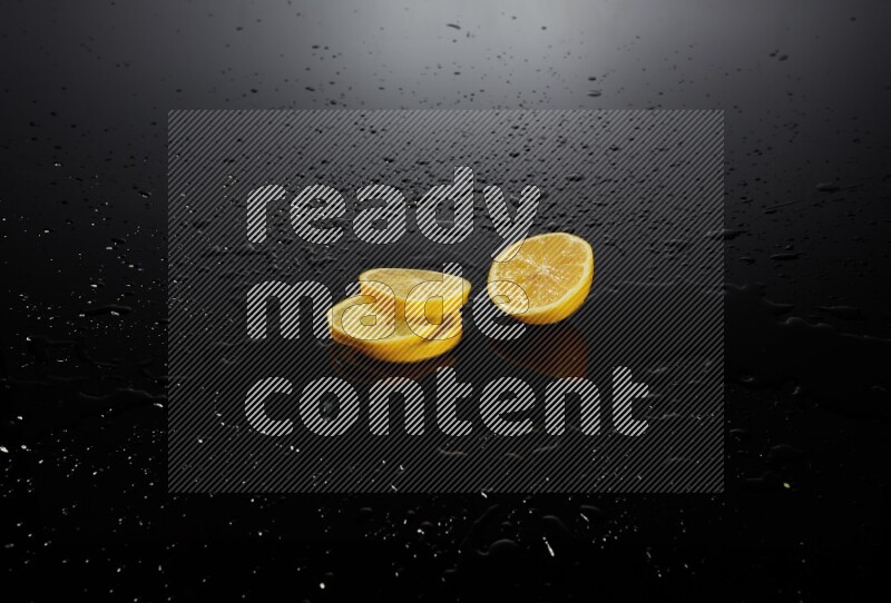 Lemon slices with water drops, and droplets on black background