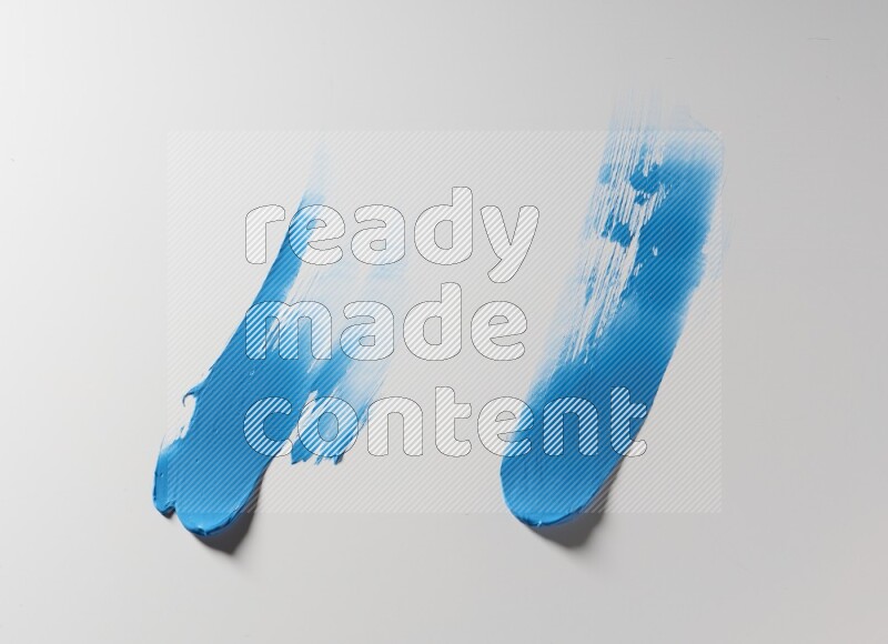 Blue curved painting knife strokes on white background