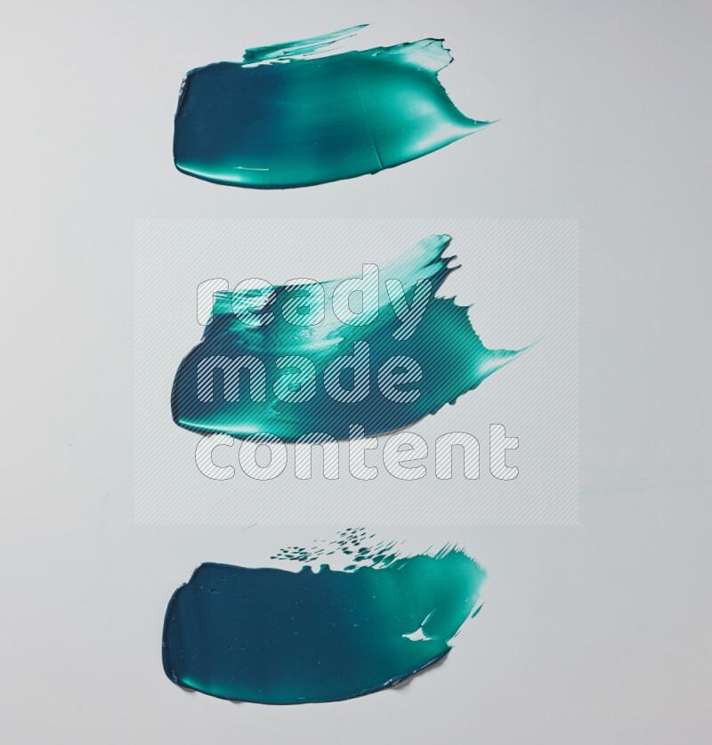 Turquoise painting knife strokes on white background