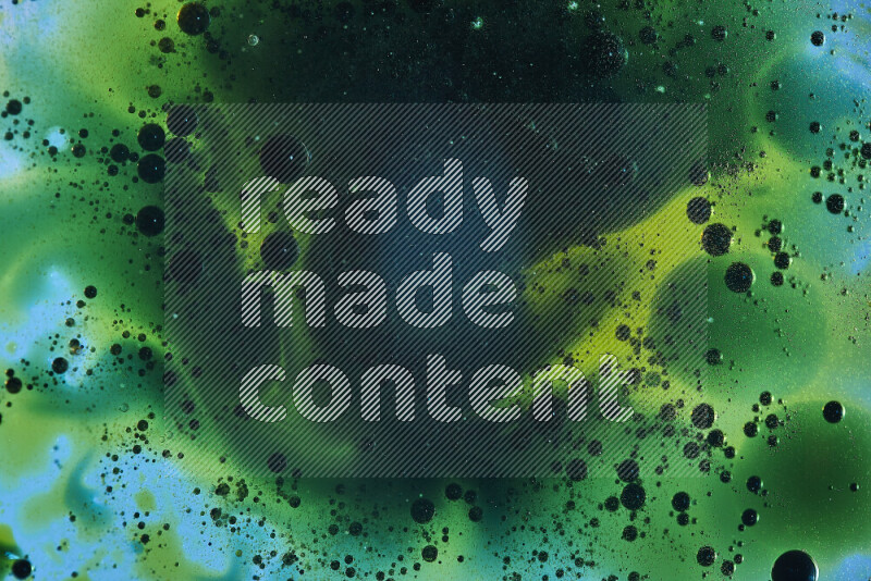 Close-ups of abstract green and blue watercolor drops on oil Surface on blue background