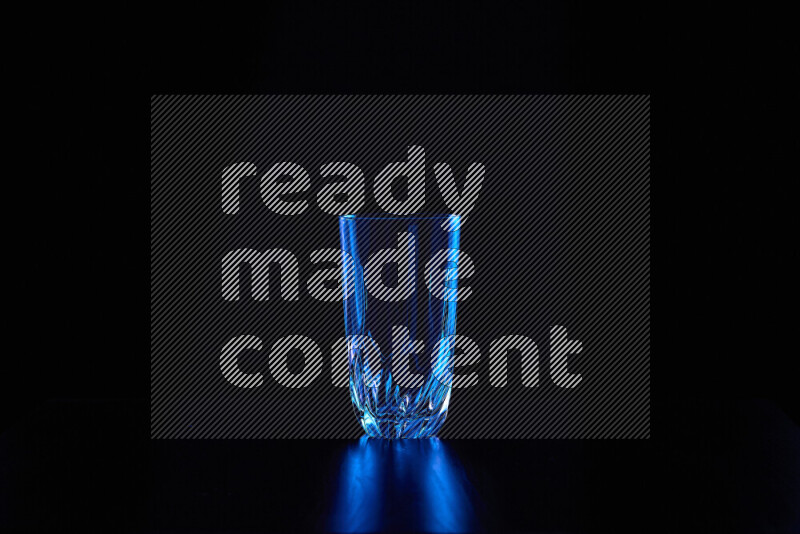 Glassware with rim light in blue against black background