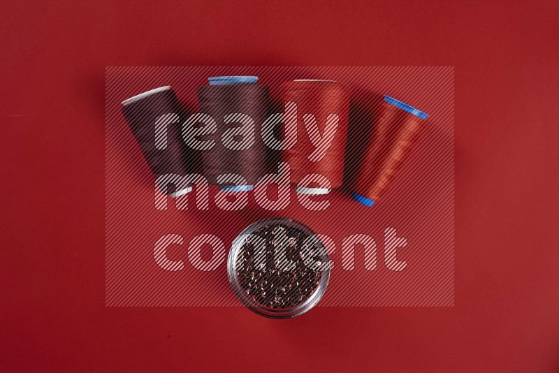 Red sewing supplies on red background