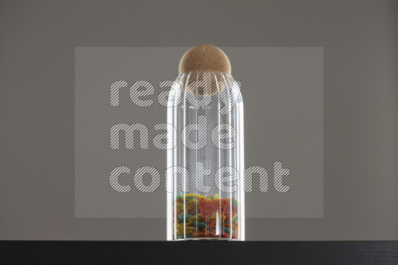 Snacks in a glass jar on black background