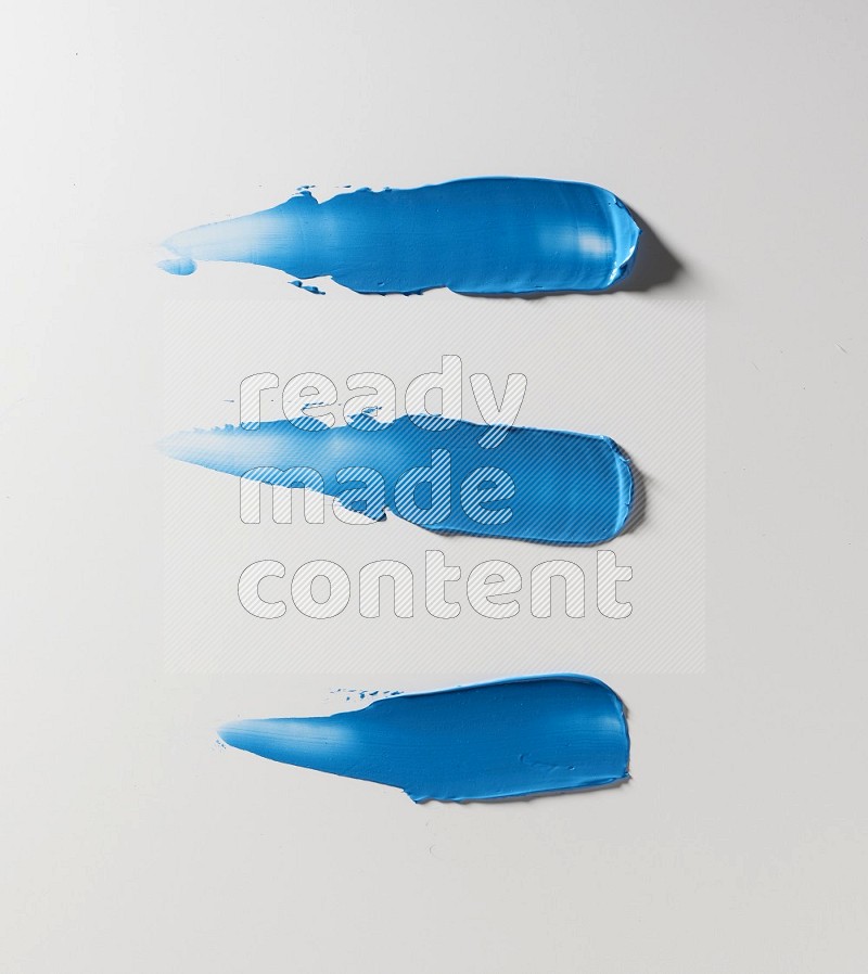 Blue painting knife strokes on white background