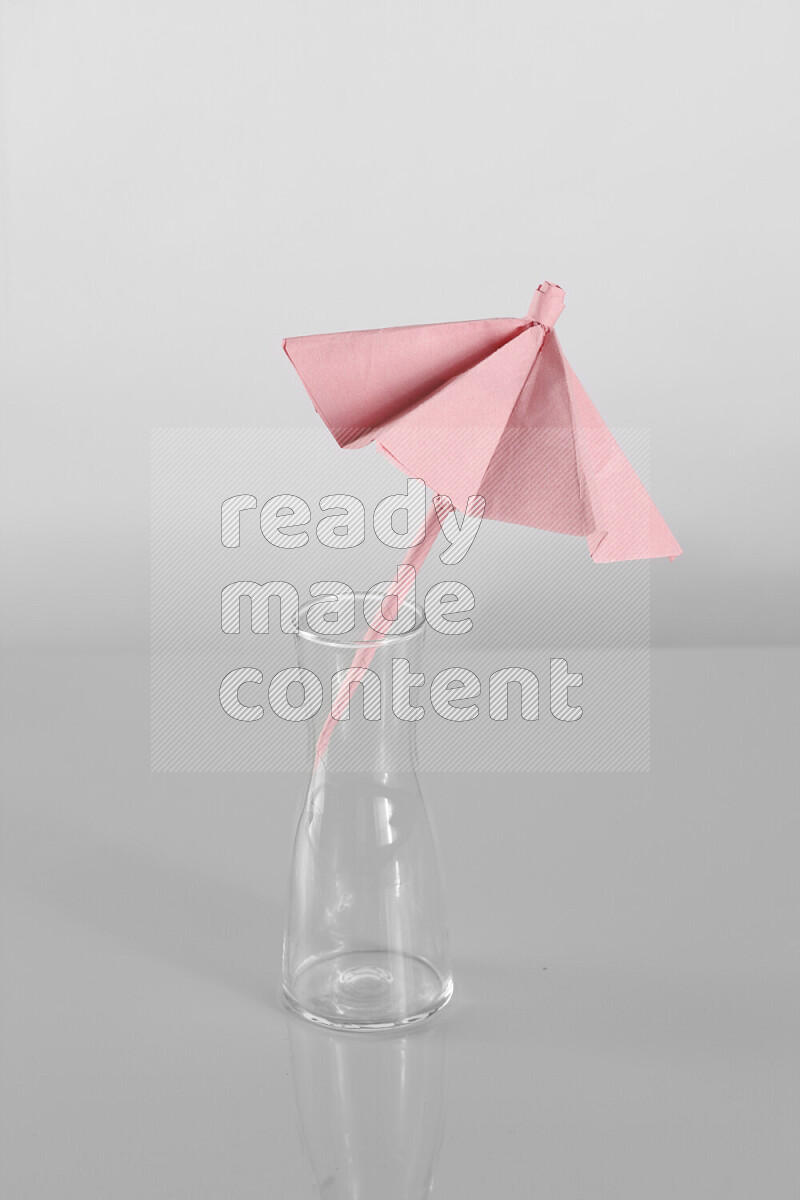 Origami umbrella on grey background