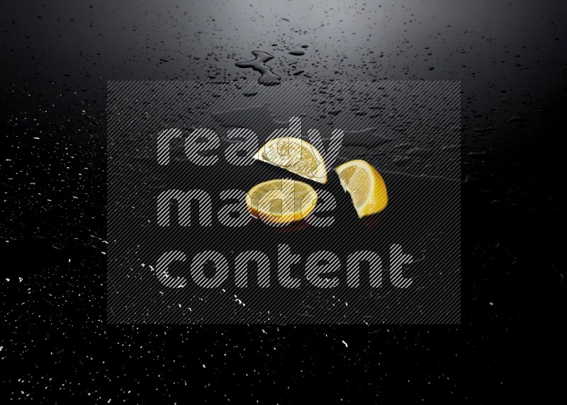 Lemon slices with water drops, and droplets on black background