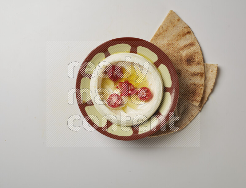Lebnah garnished with Cherry tomato in a traditional plate on a white background
