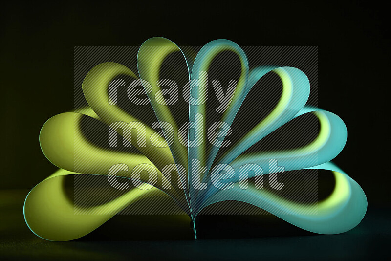 An abstract art piece displaying smooth curves in green gradients created by colored light