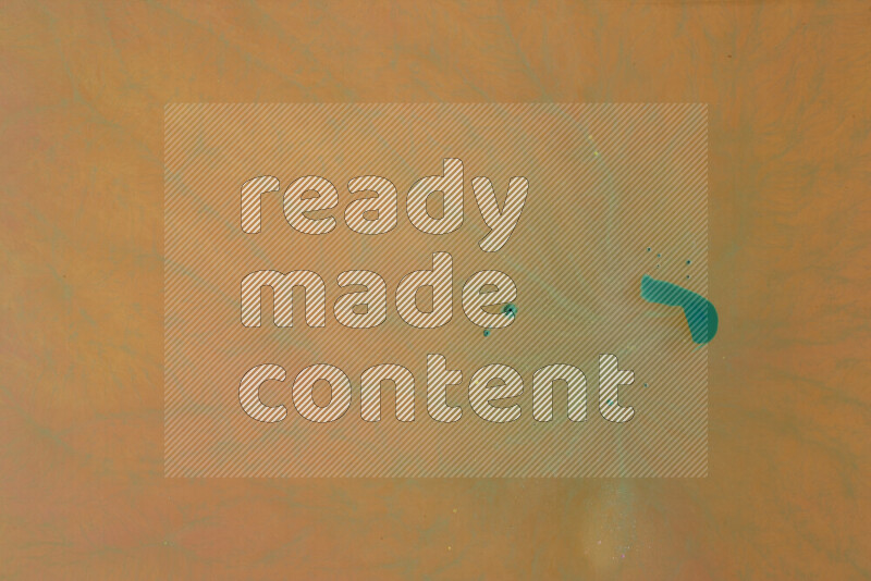 The image captures a dramatic splatter of green paint over a orange backdrop