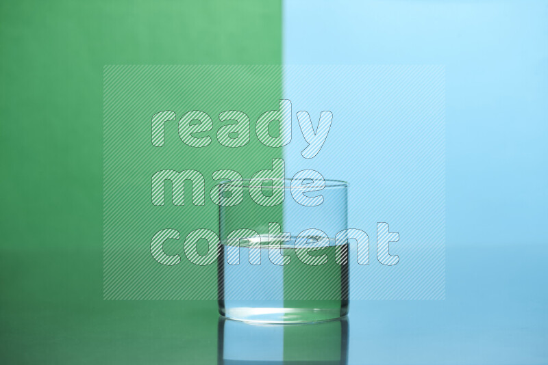 The image features a clear glassware filled with water, set against green and light blue background