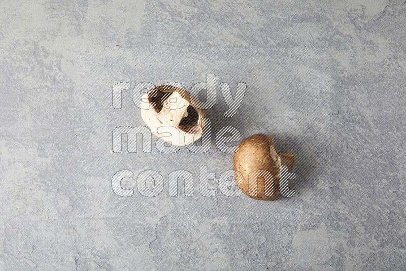 small fresh Cremini mushrooms topview on light blue background