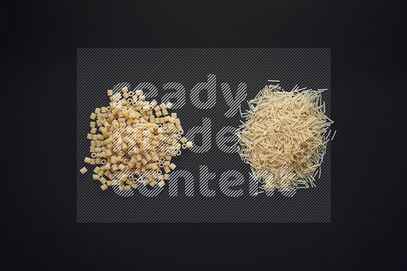 Different pasta types in bunches on black background