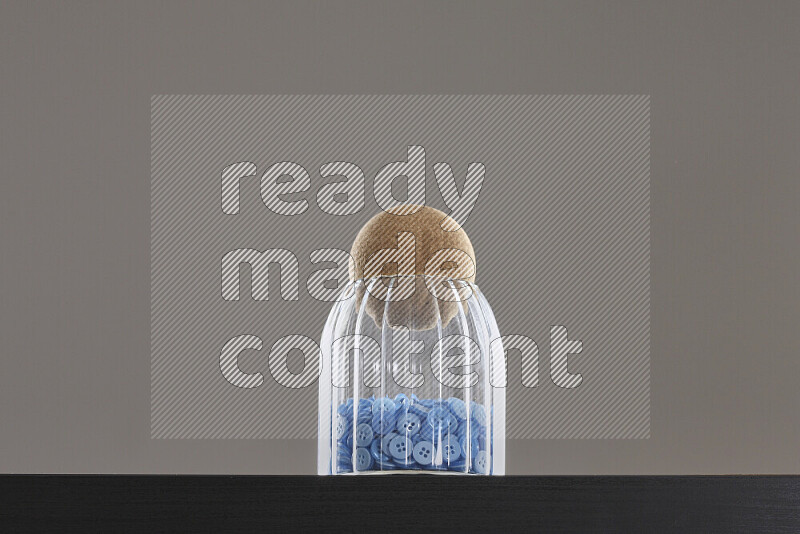 Buttons in a glass jar on black background