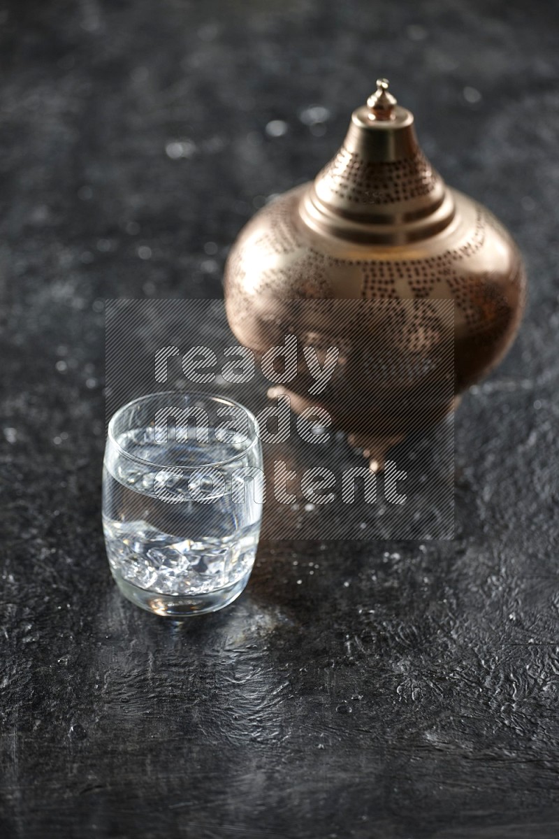 Quran with a prayer beads on textured black background