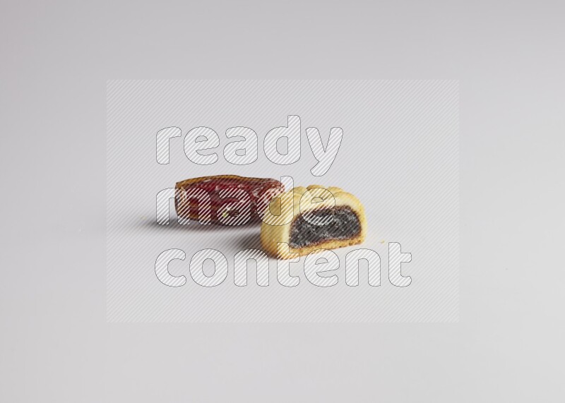 Half Maamoul filled with date with Date on the side direct on white background