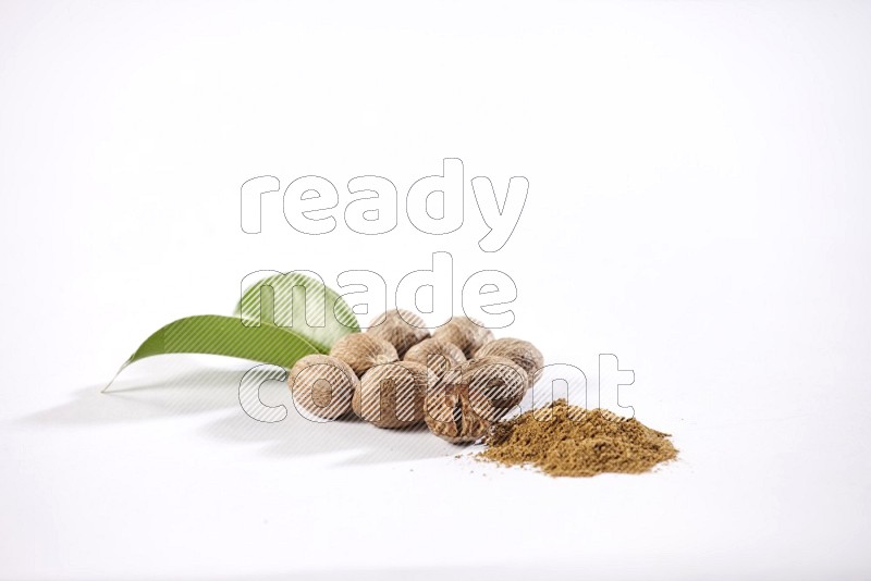 Nutmeg seeds with nutmeg powder beside it on a white flooring in different angles