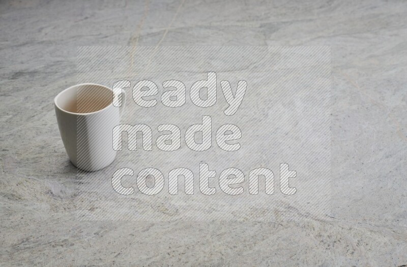 A white ceramic mug on grey marble background
