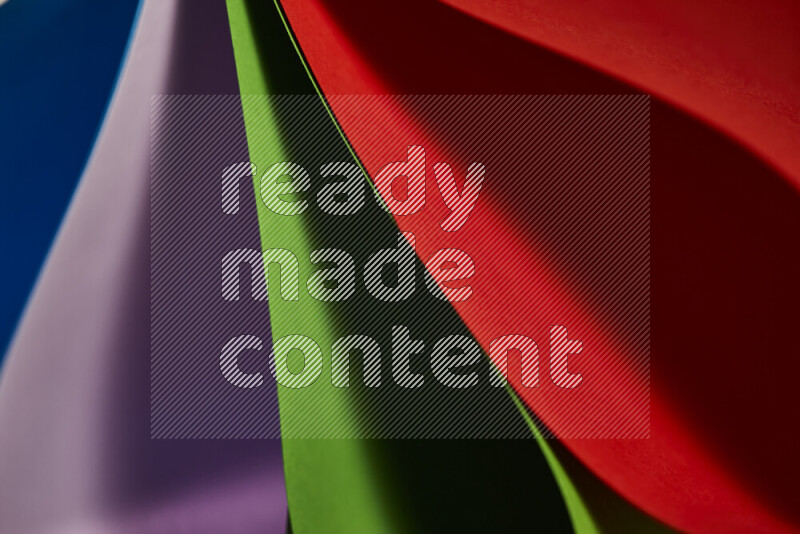 An abstract art showing colorful paper sheets arranged in an overlapping curves