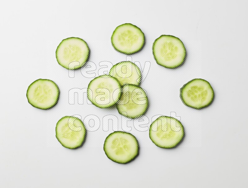 Multiple cucumber slices on white background